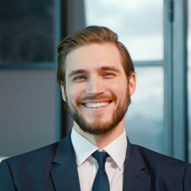 young businessman smiling looking at the camera